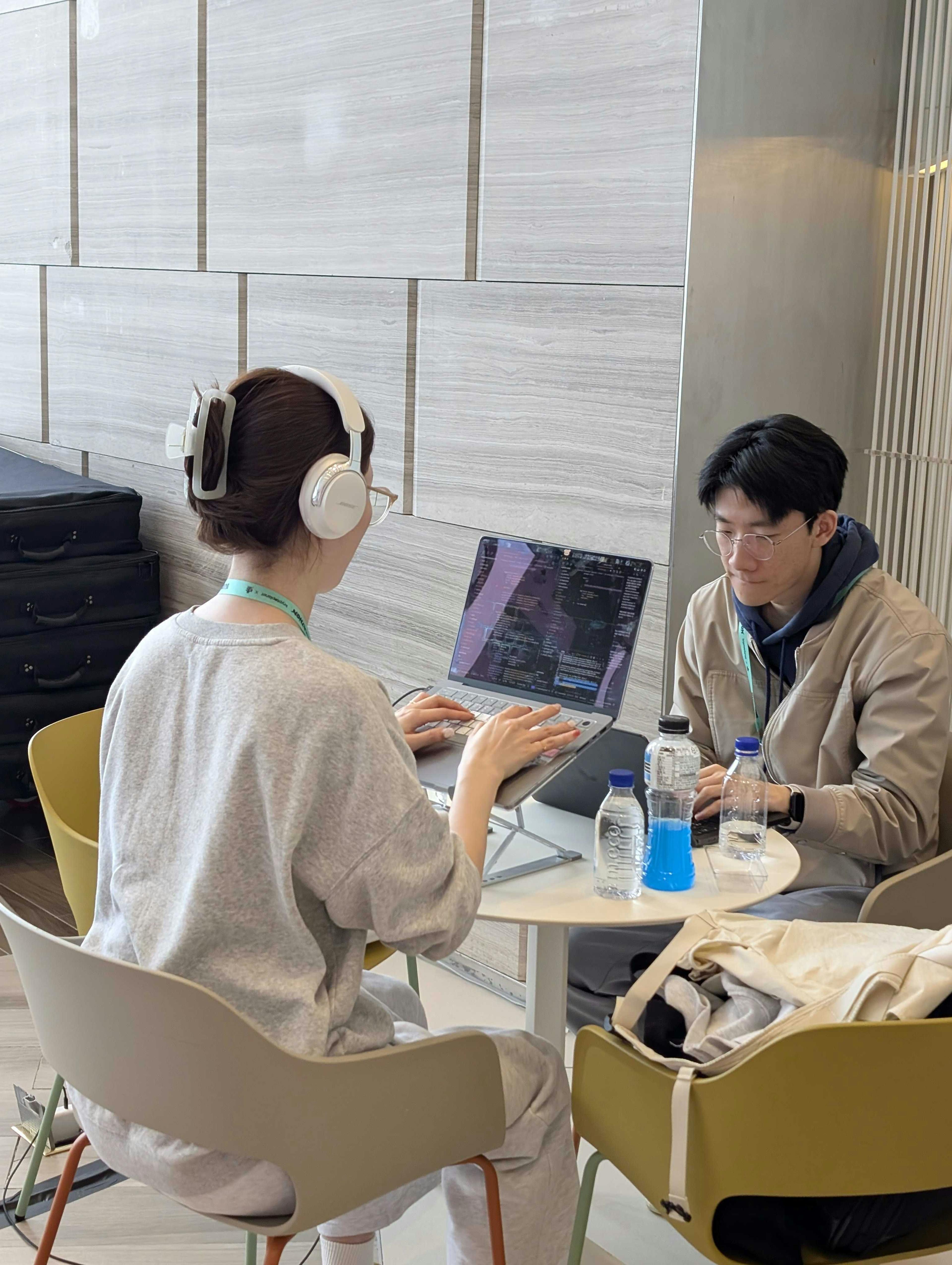 build-asia-2025-saga-hackathon-two-people-typing-on-a-computer